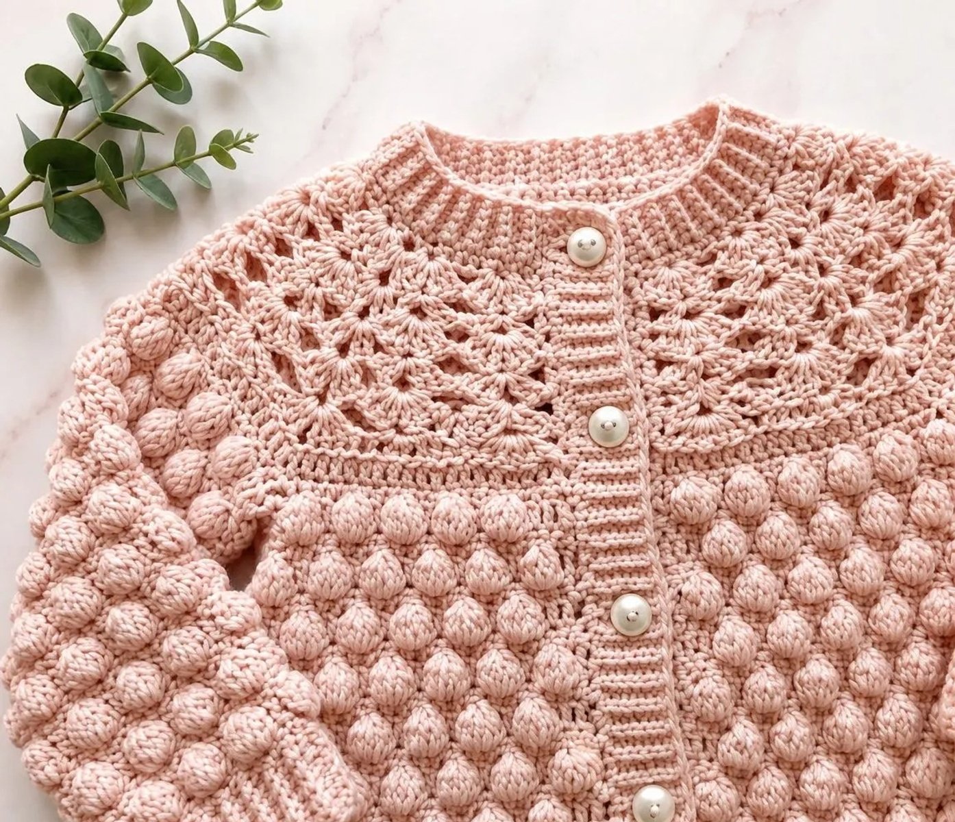 Crochet a Vintage-Inspired Baby Cardigan with Lace and Bobbles - finished dish